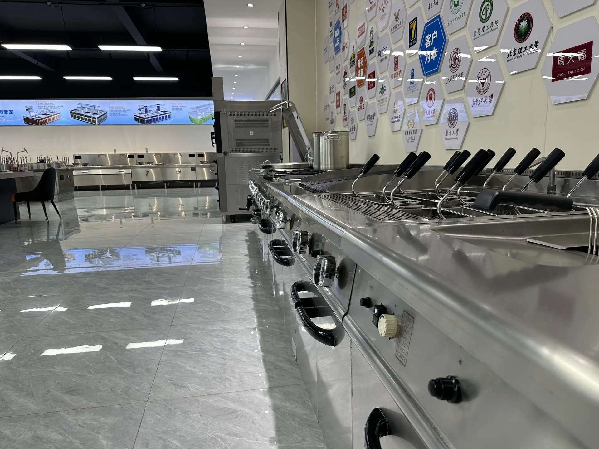 Commercial range equipment line and global partner logo wall at ProphetChef showroom