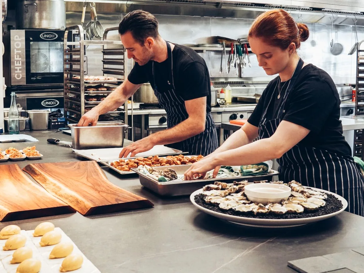 Modern standardized commercial kitchen line with stainless steel equipment and prep areas