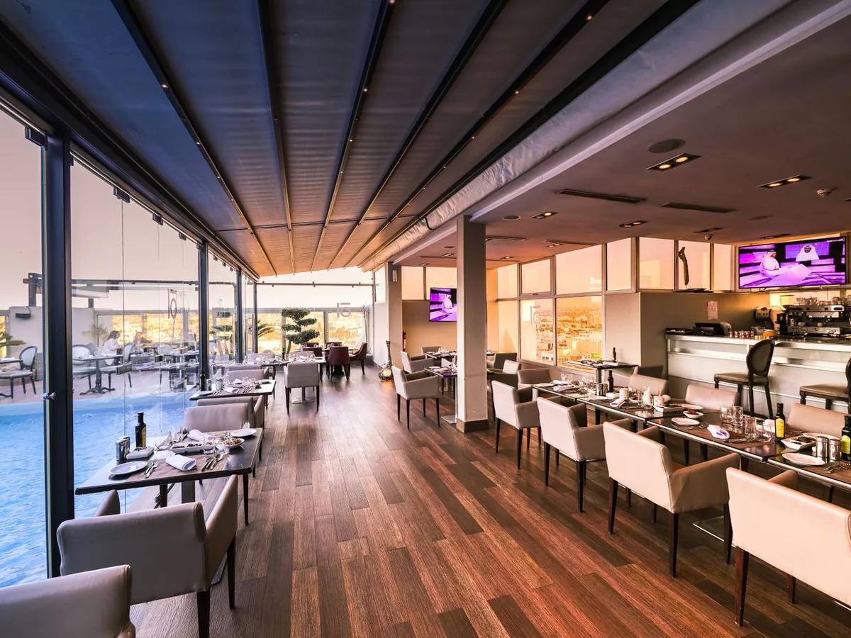 Professional kitchen with chefs cooking and plating gourmet dishes