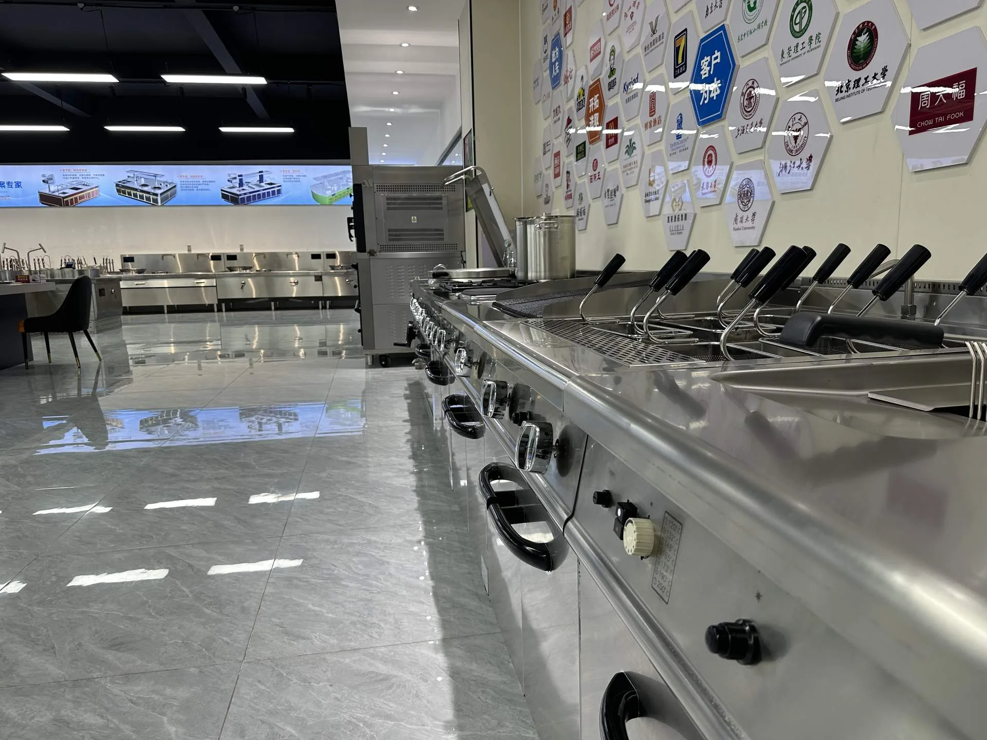 Commercial range equipment line and global partner logo wall at ProphetChef showroom